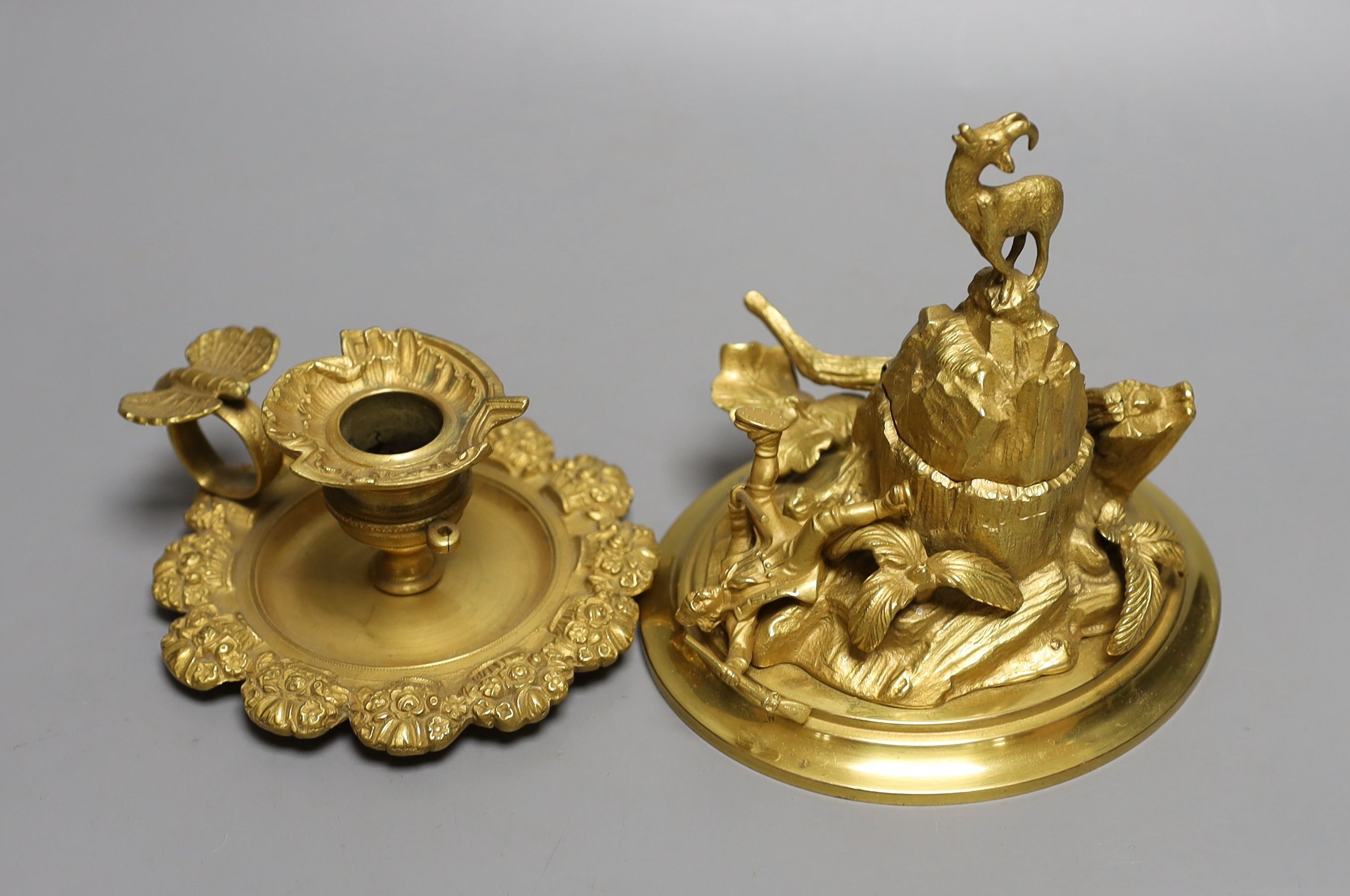 An ormolu mountainous and figurative inkstand and butterfly handled chamber stick, Inkwell 13cms high.